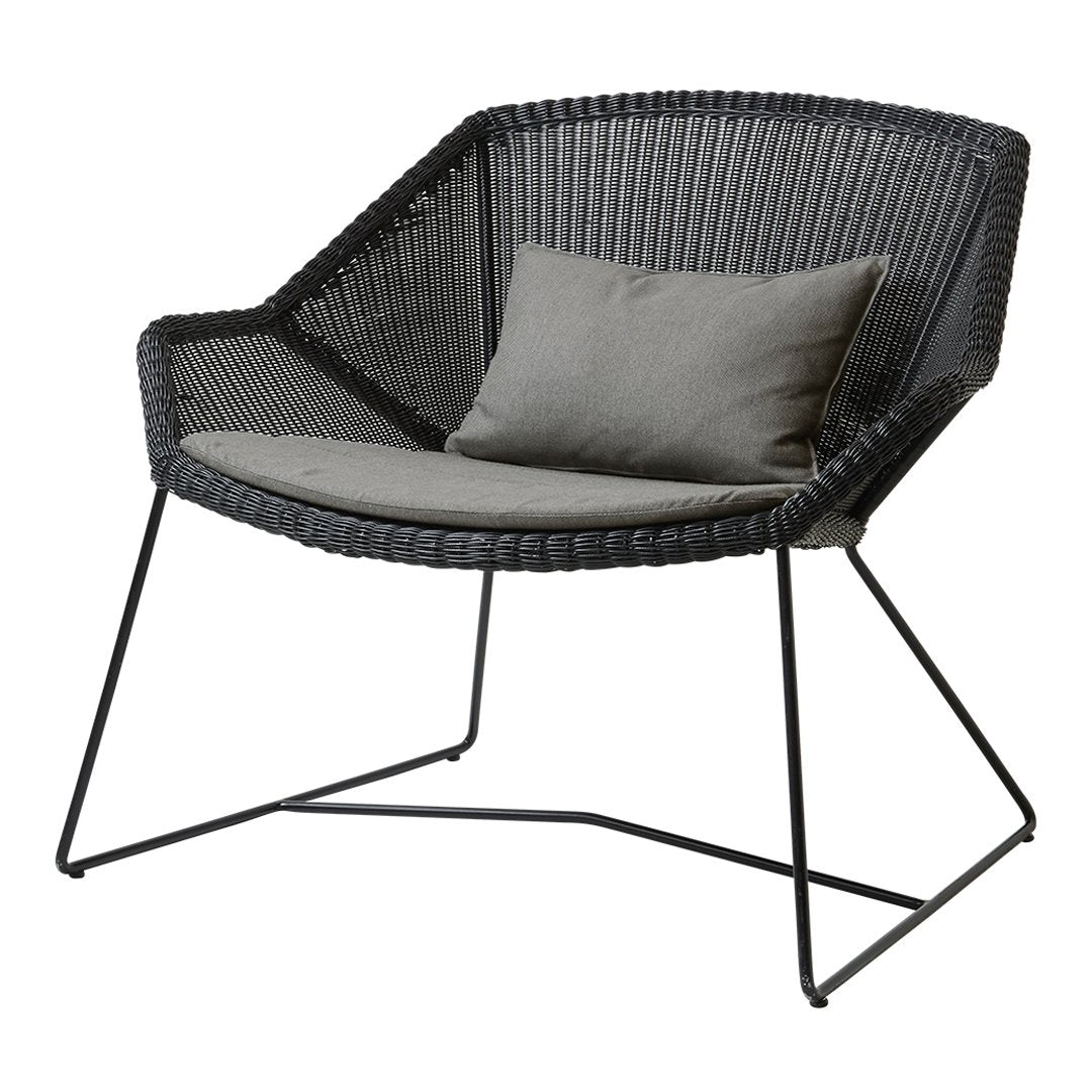 Black woven chair with a sleek, modern design and a soft gray cushion, featuring a minimalist metal frame.