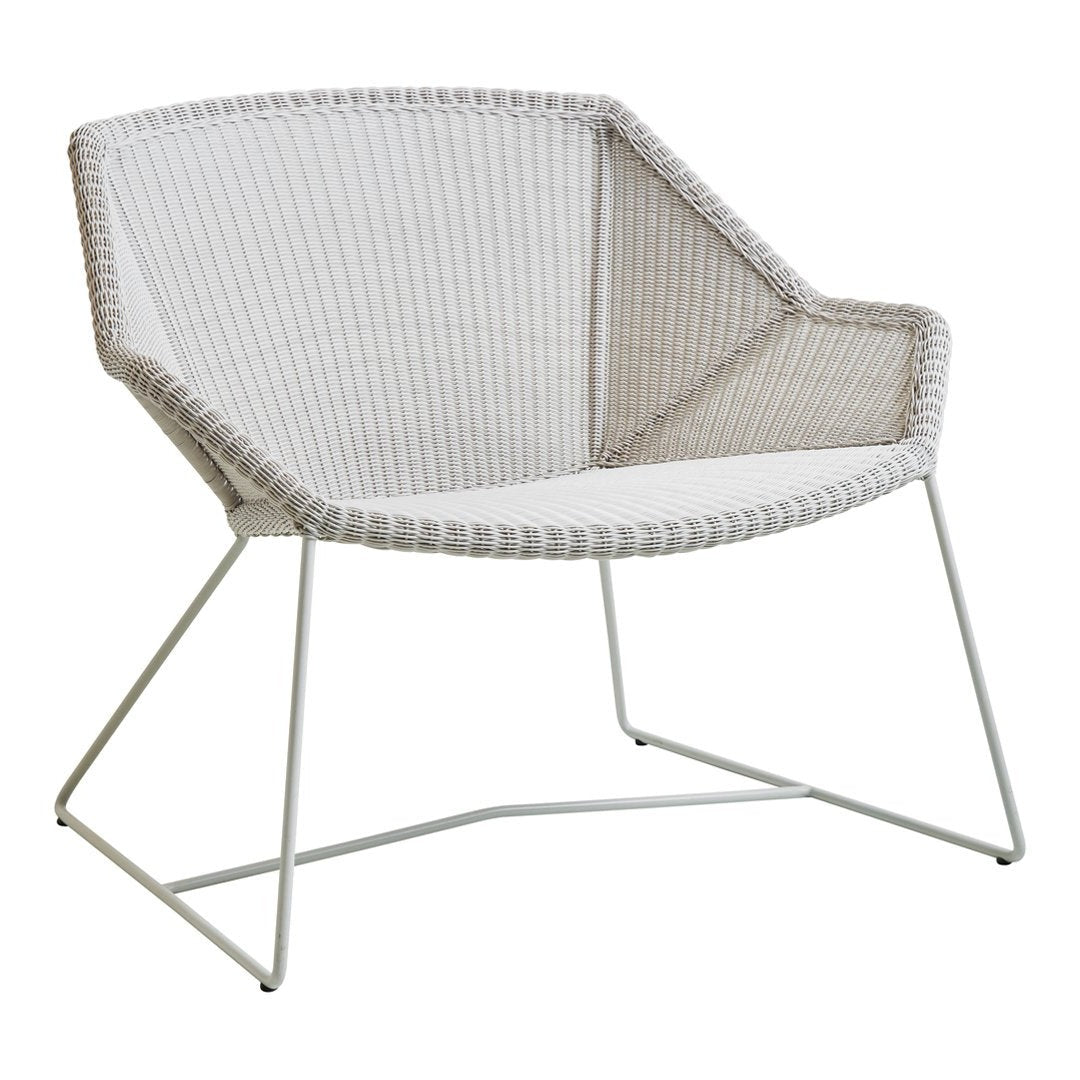 Stylish white chair with woven texture and sleek metal legs, featuring a modern geometric pattern for contemporary decor.