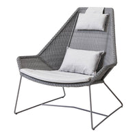 Gray woven chair with a sleek design, featuring light gray cushions for added comfort and style. Perfect for modern decor.