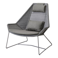 Gray woven chair with a contemporary geometric design and sleek metal legs, featuring plush cushions for added comfort.