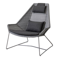 Gray lounge chair with unique geometric pattern, featuring two dark cushions for added comfort. Perfect for modern decor.