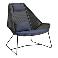 Mid-century modern chair featuring a black woven frame and dark navy cushions with a sleek geometric design.