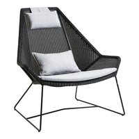 Black and gray modern chair with a geometric design and soft white cushions. Elegant and stylish addition to any space.