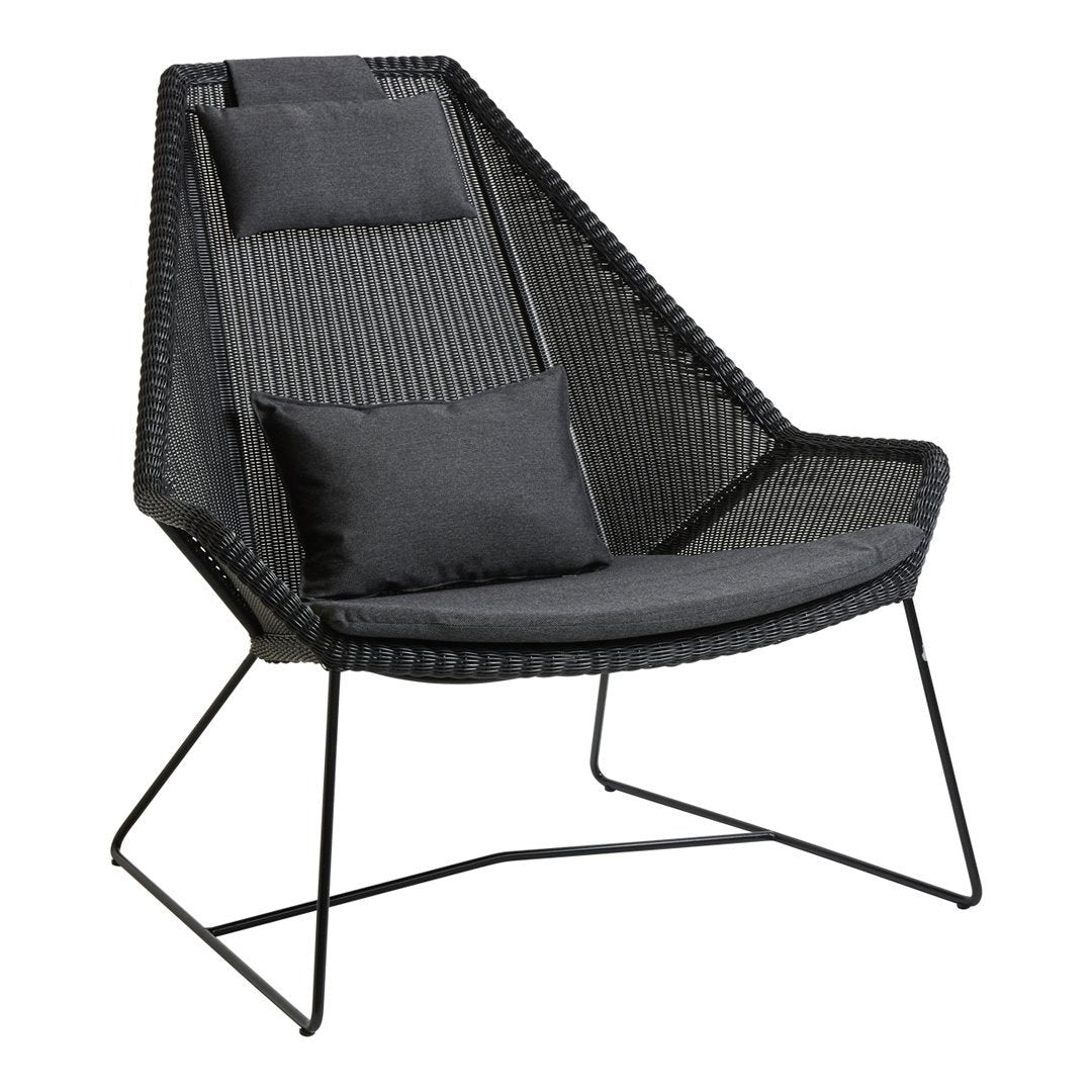 Black woven lounge chair with a sleek design, accented by two gray cushions and a modern geometric pattern.