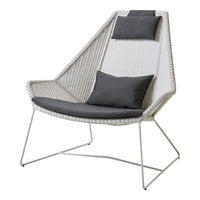 Modern chair with a white woven pattern and gray cushions. Stylish and minimalistic design for contemporary decor.