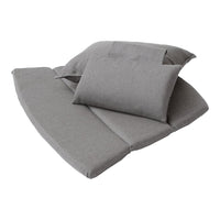 Gray textured cushions and pillows in various sizes, showcasing a simple and modern design.