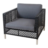 Gray cushioned chair with a black woven rattan frame and silver metal legs, showcasing a modern and textured design.