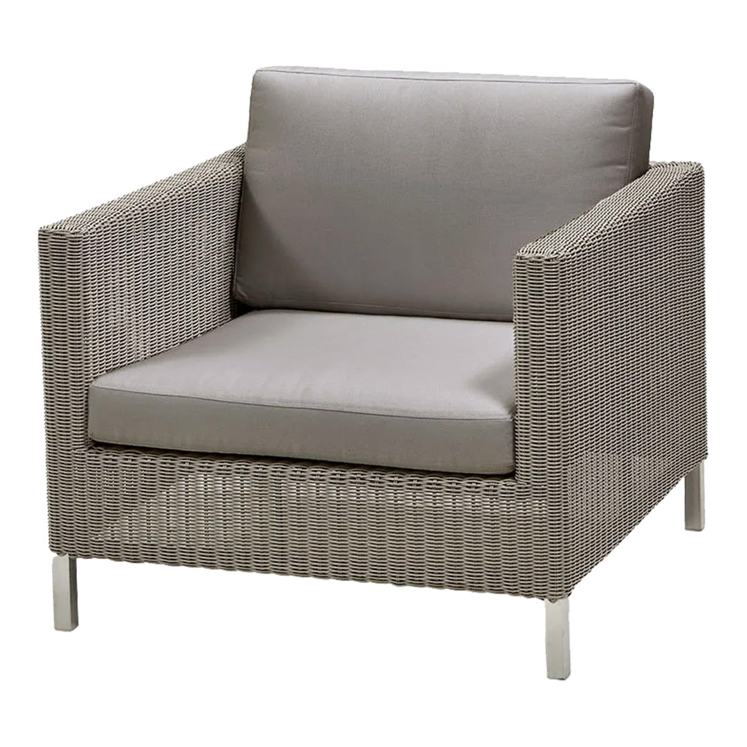 Gray wicker armchair with a smooth gray cushion, featuring a minimalist design and clean lines. Perfect for modern decor.