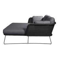 Gray wicker lounge chair with a modern black frame and plush gray cushions, offering a sleek and stylish look.
