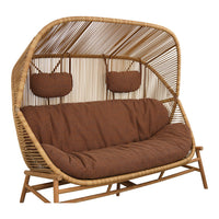 Brown cushion seating with a natural rattan frame and woven back, perfect for boho-chic outdoor decor.