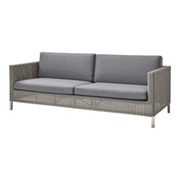 Gray wicker sofa with plush gray cushions and sleek metal legs, perfect for modern outdoor spaces.