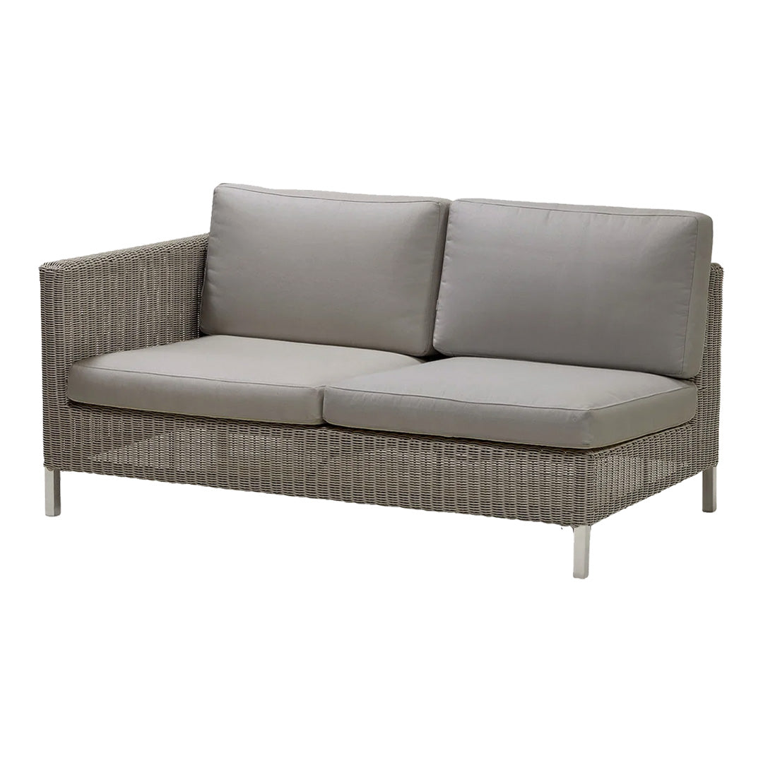Gray wicker loveseat with soft, light gray cushions for a modern, stylish outdoor seating option.