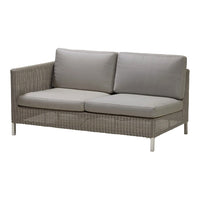 Gray wicker loveseat with soft, light gray cushions for a modern, stylish outdoor seating option.