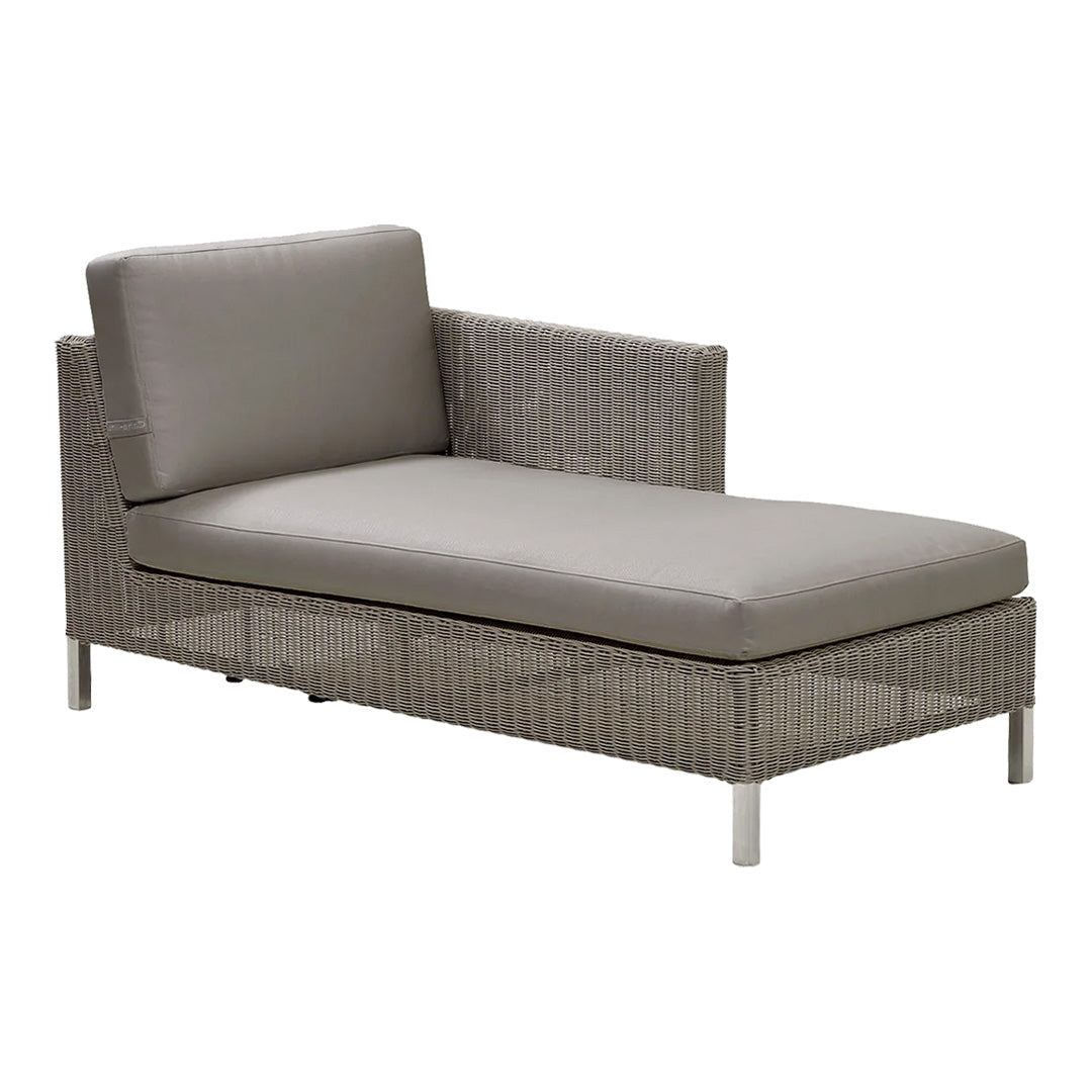 Gray wicker chaise lounge with smooth gray cushions, featuring minimalist design and contemporary aesthetic.