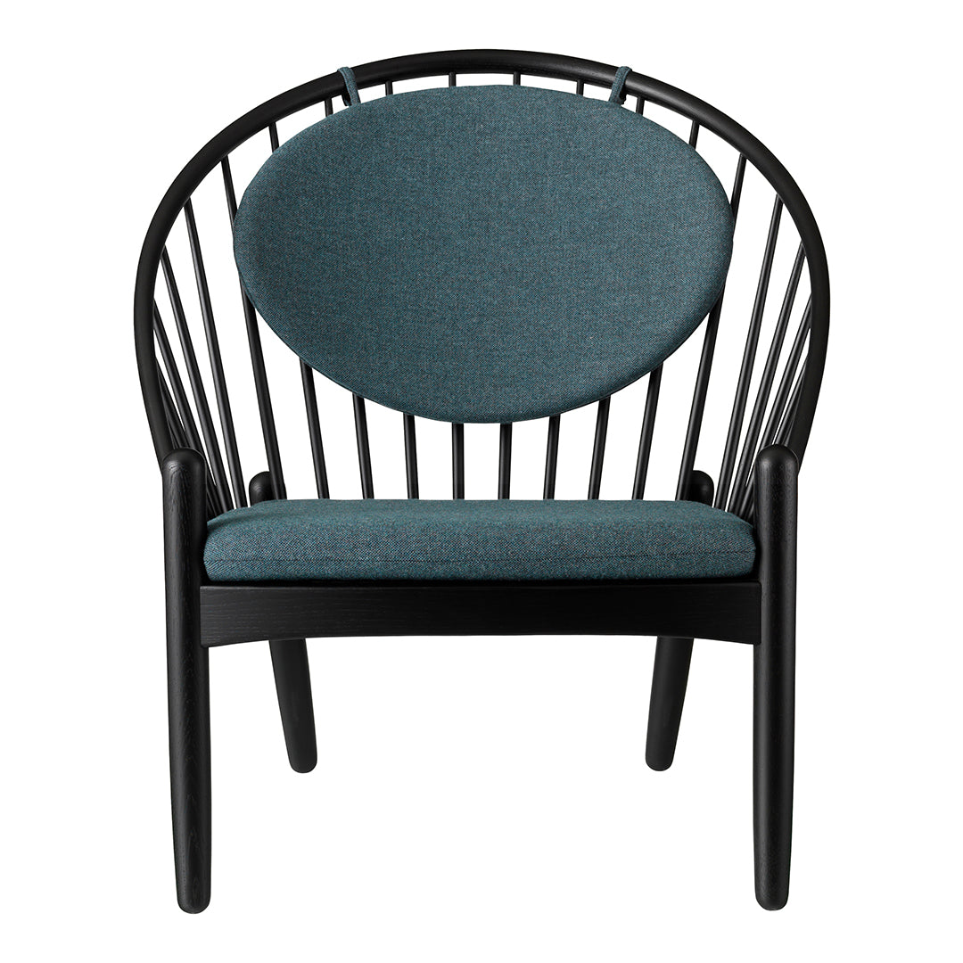 Black wooden chair with a round teal cushion and a sleek, modern design featuring open slatted back.