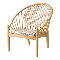 Natural wood chair with vibrant plaid upholstery in orange, blue, and cream colors, featuring a modern curved design.