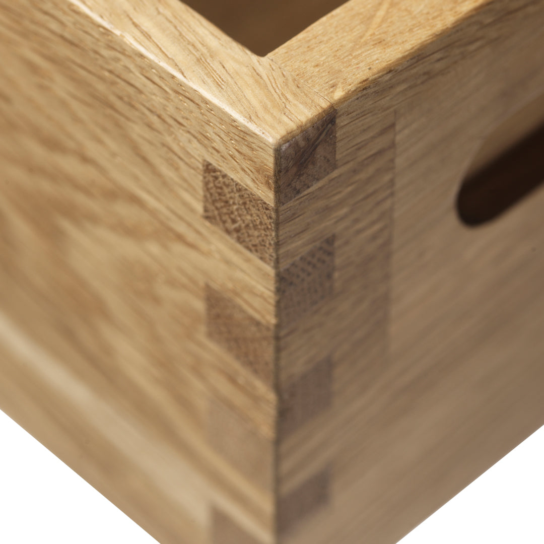 Light natural wood box with a detailed dovetail joint, showcasing warm beige and light brown tones.