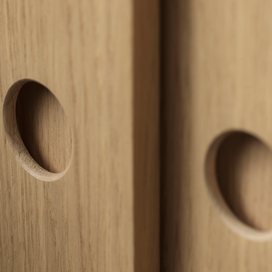 Light oak wood with smooth, circular cutouts showcasing natural grain patterns and warm tones. Perfect for modern decor.
