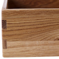 Natural wood grain with distinct light and dark patterns, showcasing a warm oak finish and seamless joinery details.