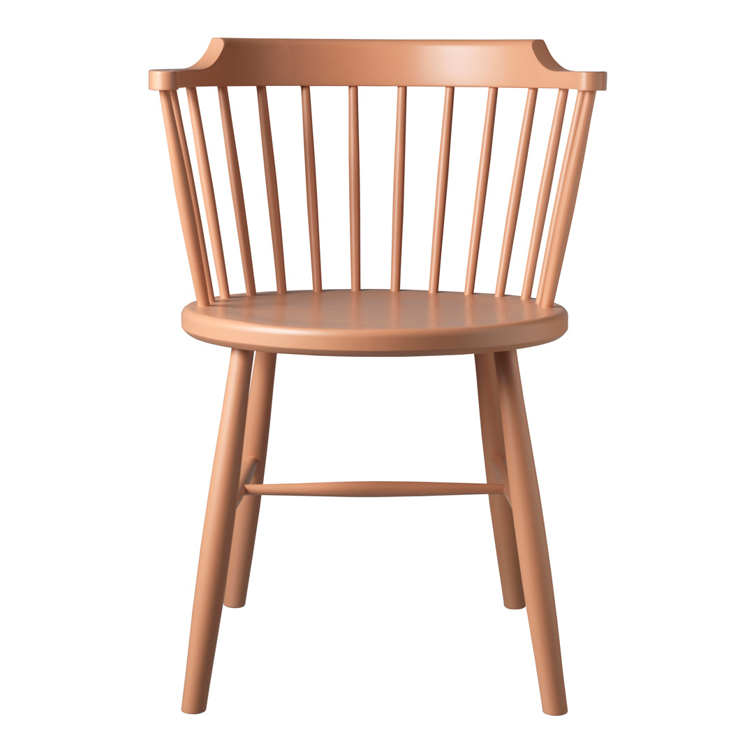 "Peach-colored wooden chair with vertical slats and a round seat, showcasing a minimalist design."