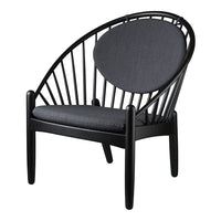 Black chair with a circular back and sleek, minimal design featuring a dark gray cushion, perfect for modern interiors.