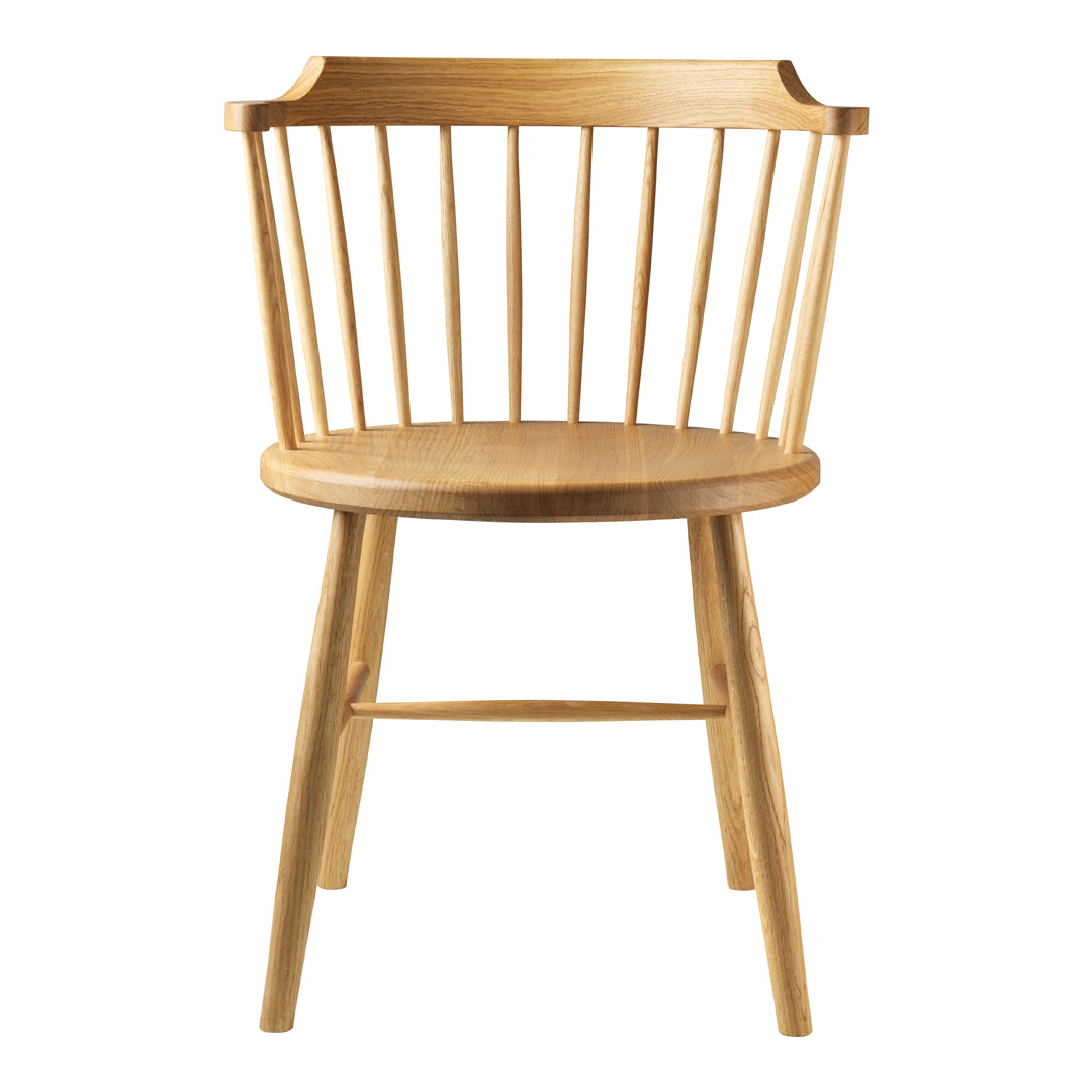 Minimalist light wood chair with vertical slats and a rounded seat, featuring a natural grain pattern.