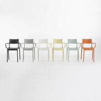 Set of six modern chairs in black, white, gray, beige, green, and orange, showcasing a smooth, minimalist design.