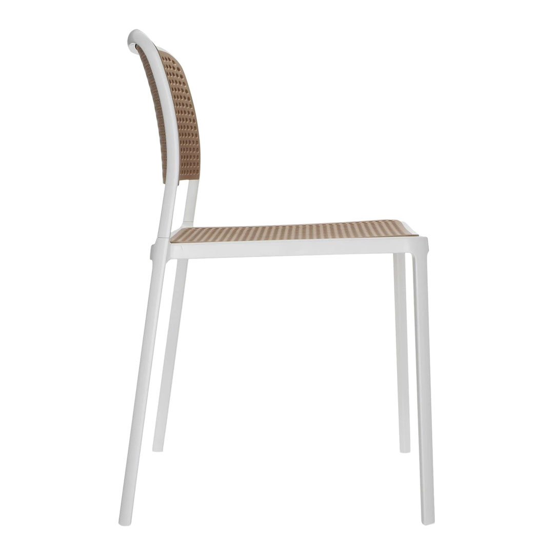 White chair with a woven brown backrest and seat, featuring a modern design and airy aesthetic.