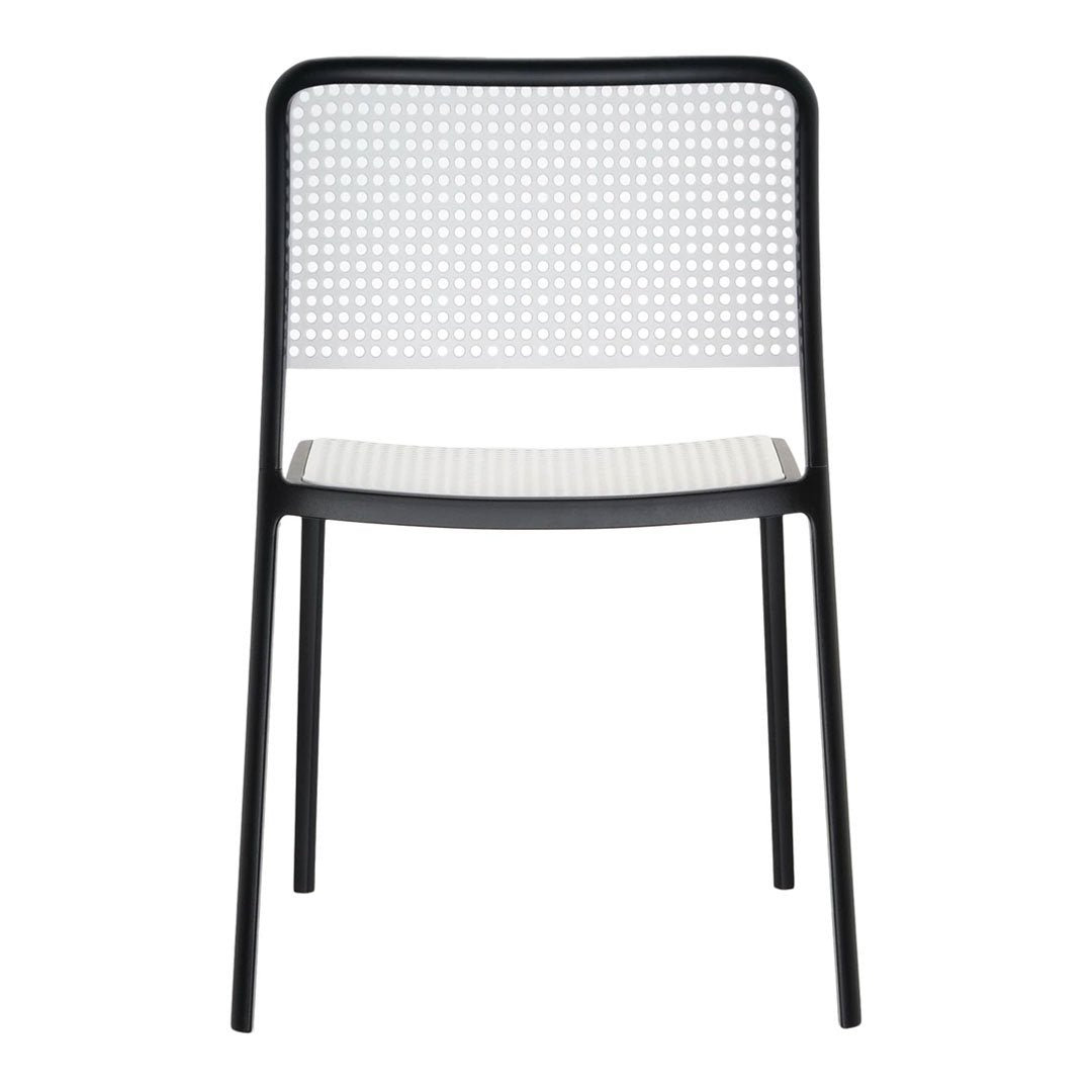 Black and white modern chair with a perforated pattern for enhanced style and breathability. Ideal for contemporary spaces.