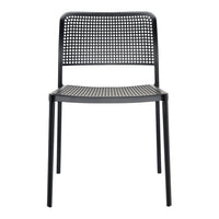 Black perforated dining chair with a sleek, minimalist design and a modern finish. Ideal for contemporary spaces.