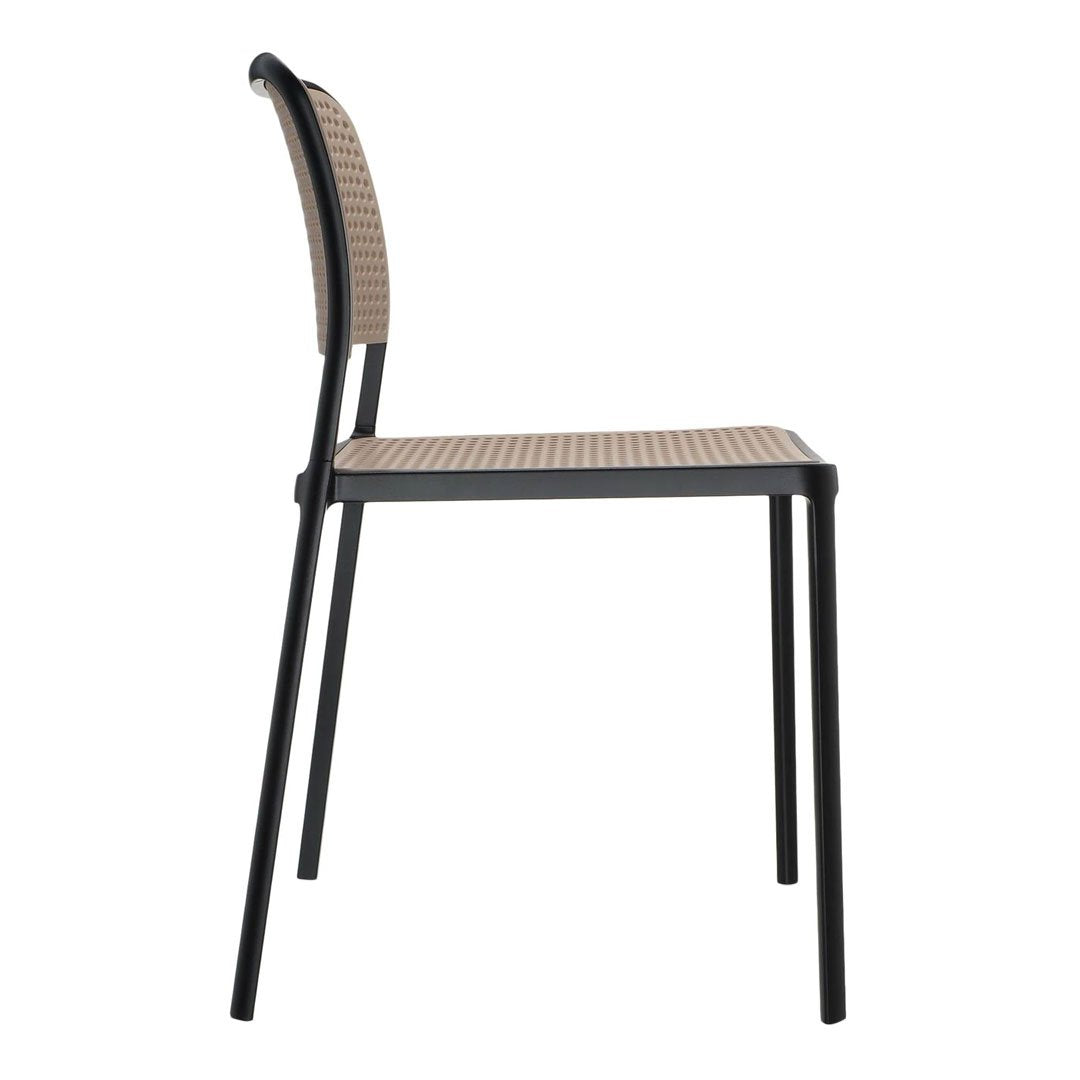 Side view of a black metal chair with a woven beige seat and back, featuring a simple geometric pattern.