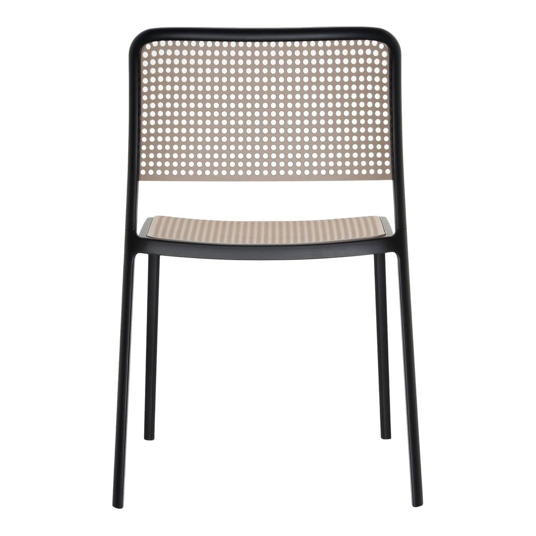 Black-framed chair with a beige woven seat and patterned backrest, showcasing a modern design.