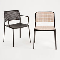 Two stylish chairs: one black with a grid-like back, and one tan with a checkered pattern. Modern and minimalist design.