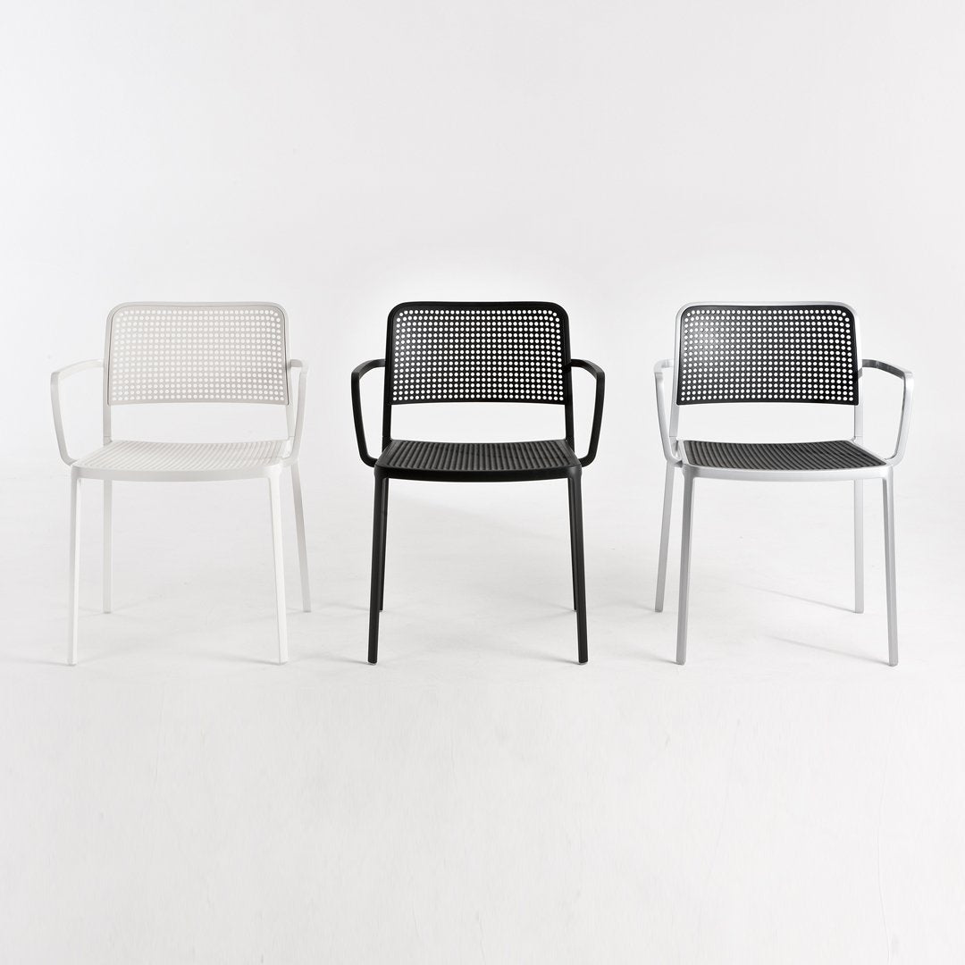 Set of three stylish chairs in white, black, and gray with a modern mesh pattern and sleek metal frames.