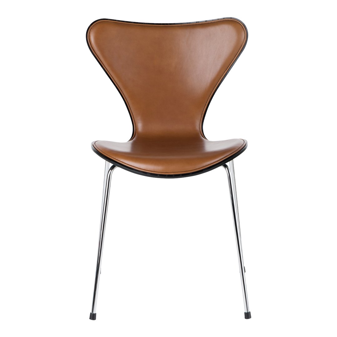 Brown leather chair with a curved design and chrome legs, showcasing a sleek, minimalist aesthetic.