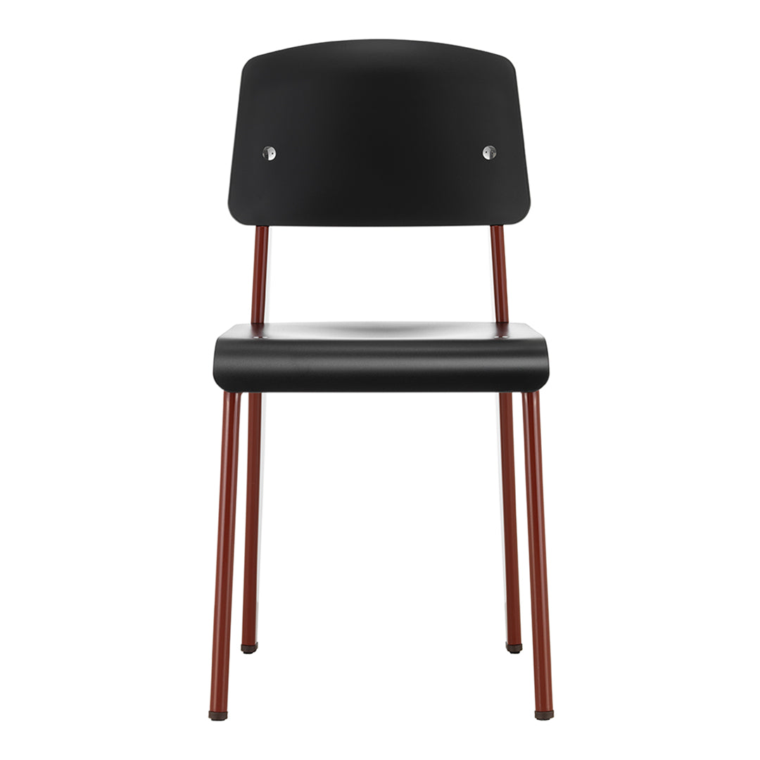 Black chair with a sleek matte finish and contrasting rust-colored legs. Minimalist design enhances modern decor.