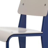 Gray and blue chair showcasing a sleek, modern design with a smooth surface and contrasting colors.