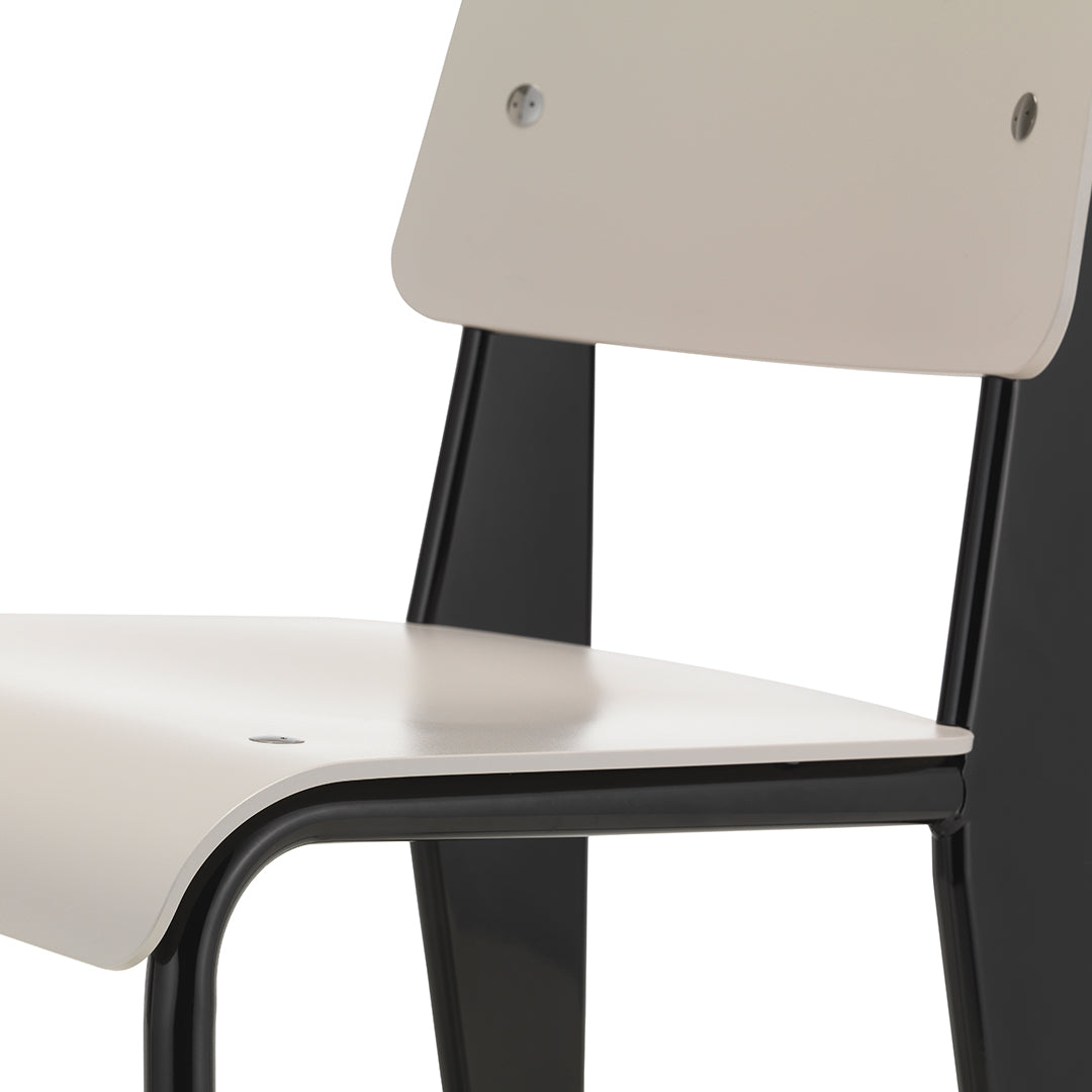 Light beige seat and backrest with a sleek black frame, featuring minimalistic design and smooth surfaces.