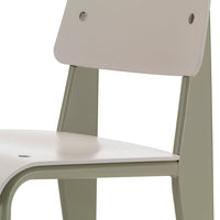 Minimalist chair with a soft beige seat and olive green legs, featuring a sleek, modern design.
