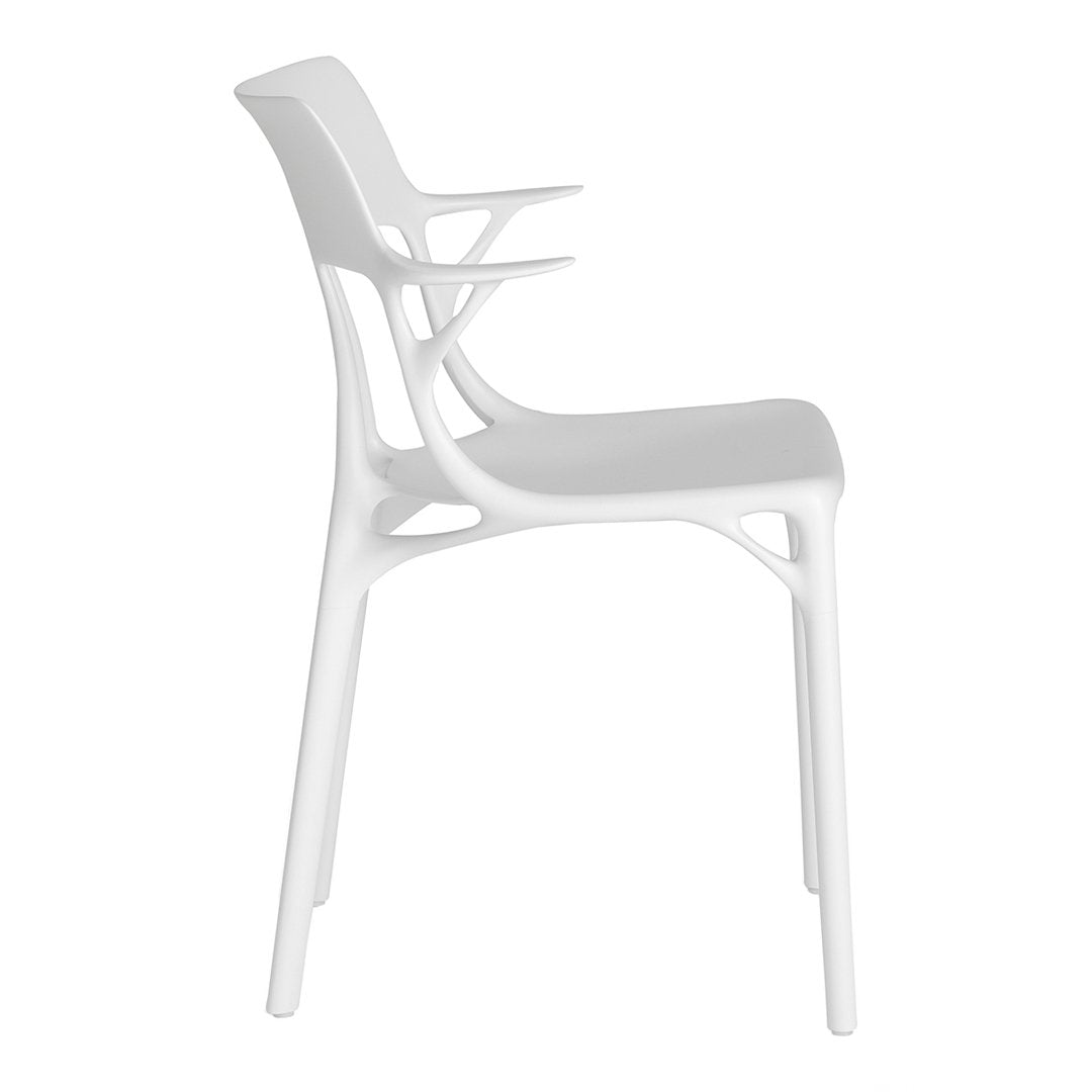 Sleek white modern chair with a minimalist design, featuring clean lines and a smooth finish.