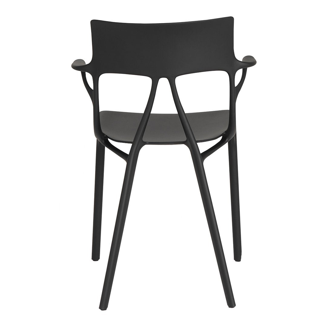 Black modern chair with a sleek design and intricate backrest pattern, perfect for contemporary spaces.