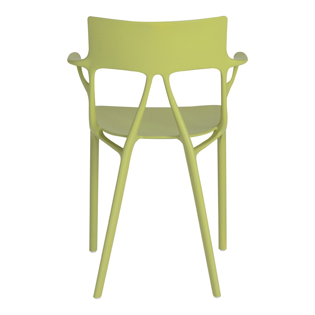 Light green chair with a modern design and unique cutout pattern. Ideal for contemporary spaces.