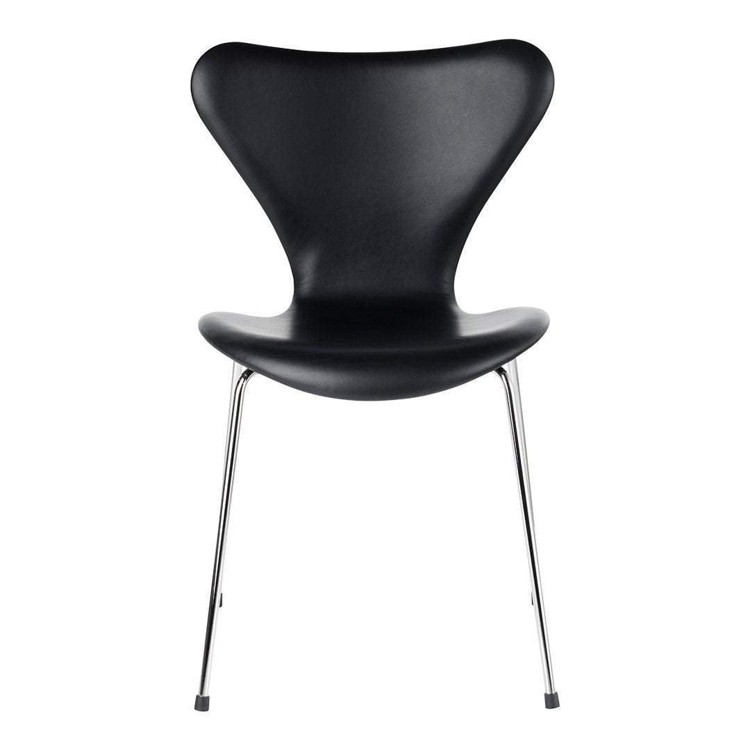 Black chair with a unique butterfly shape and sleek chrome legs, showcasing a modern and minimalist design.