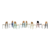 Colorful wooden chairs in varied shades: natural wood, blue, green, red, and black, showcasing modern design and patterns.