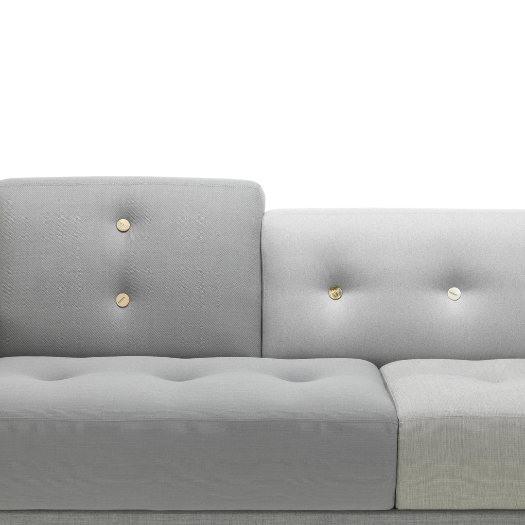 Gray tufted sofa with subtle textured pattern and gold button accents, adding a modern and stylish touch to any space.