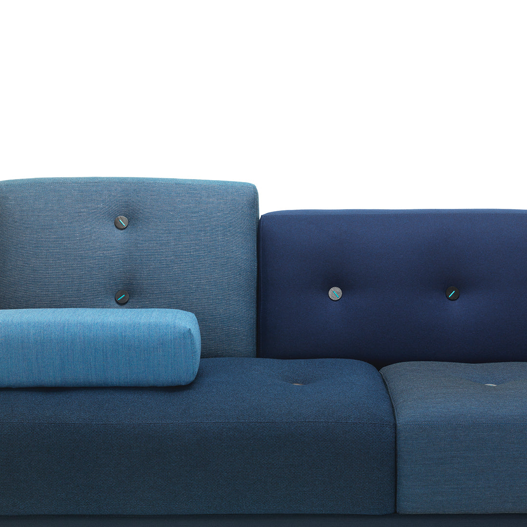 "Modern sofa in varying shades of blue with button detailing and textured upholstery."