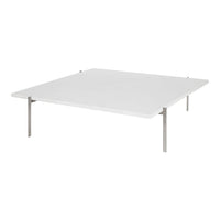 Modern white tabletop with sleek stainless steel legs, offering a minimalist design and clean lines. Perfect for any decor.