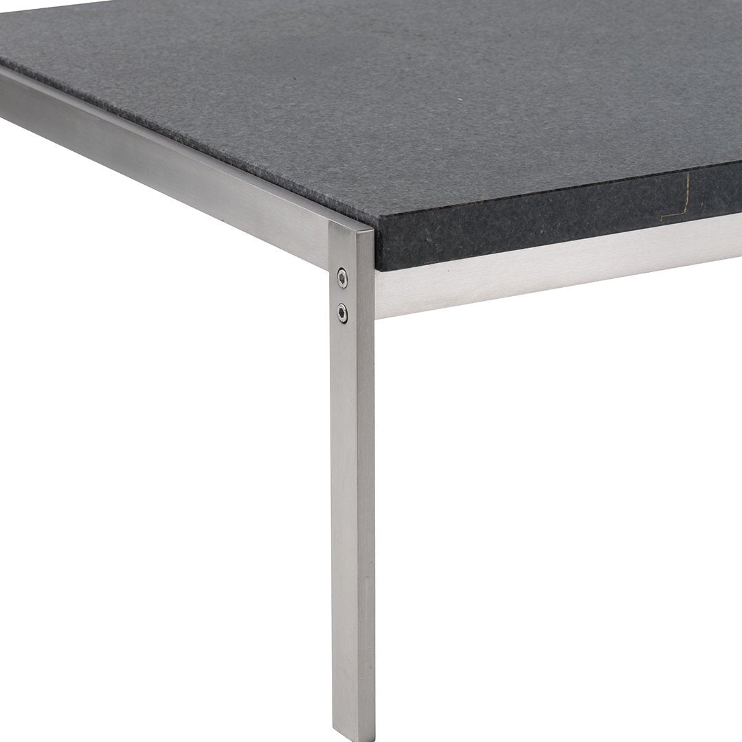 Gray stone tabletop with sleek stainless steel legs, combining modern aesthetics and durability.