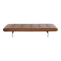 Tan tufted bench with sleek silver legs, featuring a smooth leather texture and minimalist design.