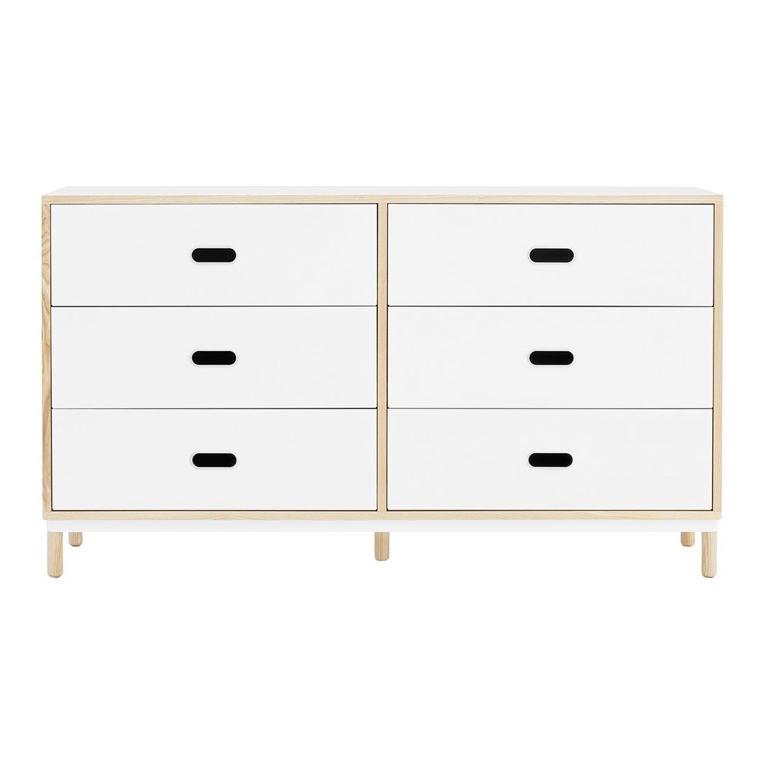 White dresser with minimalist design, featuring four drawers and contrasting black handles. Light natural wood frame.